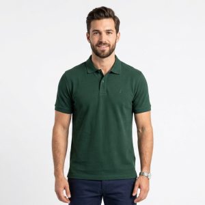Man wearing a premium men's forest green polo shirt featuring a small embroidered tree logo on the chest