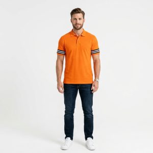 Man wearing a premium men's vibrant orange polo shirt with bold black and white striped sleeve cuffs