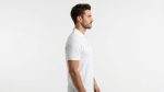 Man wearing premium men's white polo shirt with navy blue tipped collar and cuffs