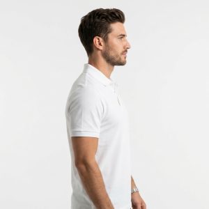 Man wearing premium men's white polo shirt with navy blue tipped collar and cuffs