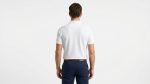 Man wearing premium men's white polo shirt with navy blue tipped collar and cuffs
