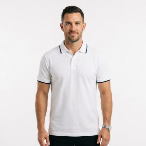 Man wearing premium men's white polo shirt with navy blue tipped collar and cuffs