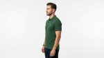 Man wearing a premium men's forest green polo shirt featuring a small embroidered tree logo on the chest