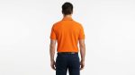 Man wearing a premium men's vibrant orange polo shirt with bold black and white striped sleeve cuffs