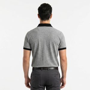Man wearing a premium men's heather grey polo shirt featuring a contrast black chest pocket and black collar