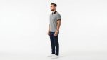 Man wearing a premium men's heather grey polo shirt featuring a contrast black chest pocket and black collar