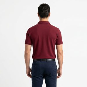 Man wearing a premium men's burgundy maroon polo shirt with a gold embroidered laurel wreath logo on the chest