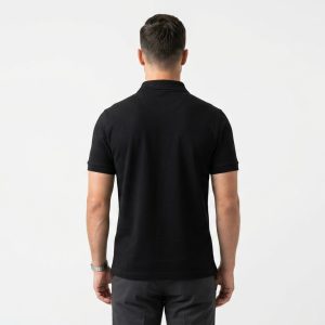 Man wearing a premium men's obsidian black polo shirt with a silver tipped collar and an embroidered A logo on the chest